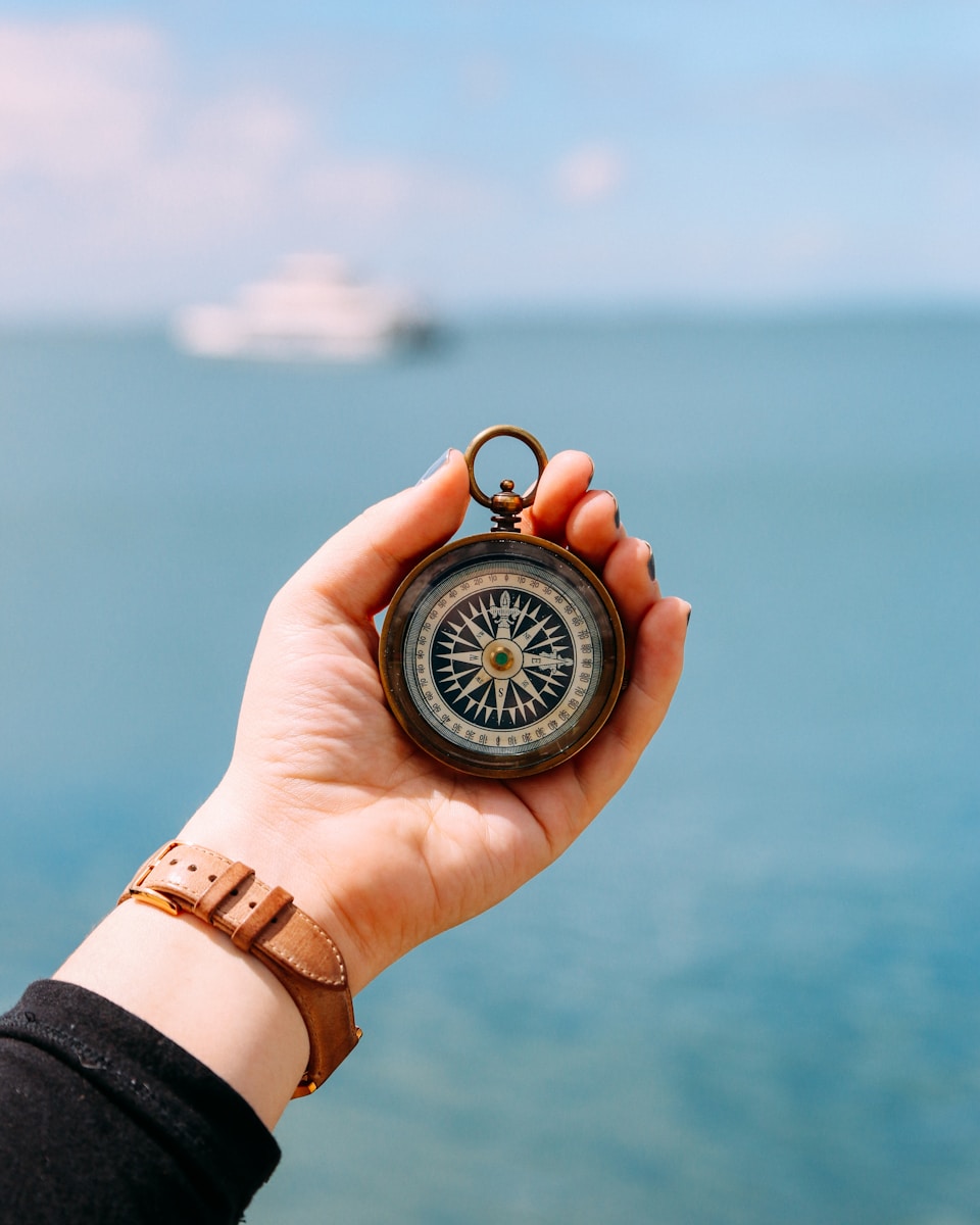 Photo by Heidi Fin person holding compass